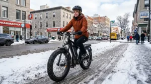 A suspension fat tire e-bike navigating a snowy Montreal bike lane during winter.