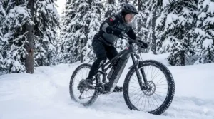 Illustration of an e-MTB equipped for Canadian winter trails with mid-drive motor detail.