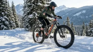 A full suspension ebike with studded fat tires navigating a snowy Canadian trail for winter traction.