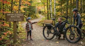 A versatile hardtail electric mountain bike transitioning from a gravel path to a paved Vancouver city street with integrated fenders.