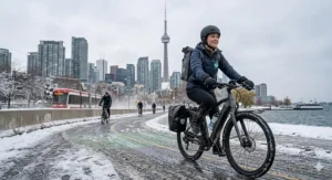 An e-bike rider navigating a slushy Toronto bike lane in winter, highlighting all-season durability.