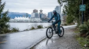 A versatile electric bike transitioning from a gravel trail to a Vancouver city path, highlighting dual-use capability.