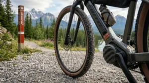 Detailed view of wide, high-traction gravel ebike tires suitable for the loose limestone and dirt of the Trans Canada Trail.