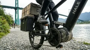 A photorealistic rear-quarter view of a cargo ebike with 300 lbs capacity, featuring heavy-duty storage crates and a reinforced frame design.