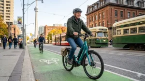 A senior commuter using a step-through electric bike in a Canadian urban bike lane.