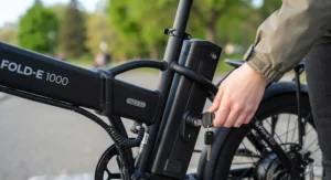 Close-up view of the removable lithium battery on a budget folding e-bike under $1000 CAD.