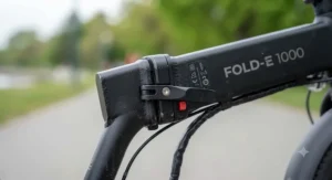 Close-up of the sturdy metal locking hinge mechanism on a reliable folding e-bike under $1000 CAD.