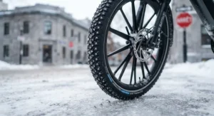 Close-up of studded winter tires on an urban ebike designed for icy Canadian weather.