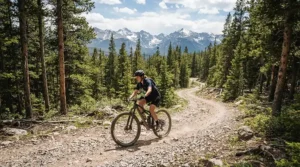 An adventurous rider tackling a gentle gravel trail with the best e-bike for women near the Canadian Rockies.